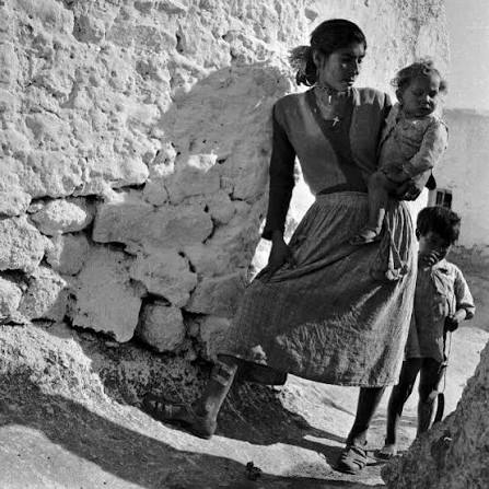 A black-and-white photograph of daily life in a Spanish village